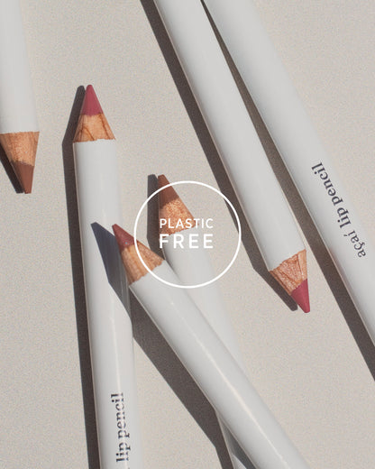 Lip pencils with wooden accents on a light background, featuring the &