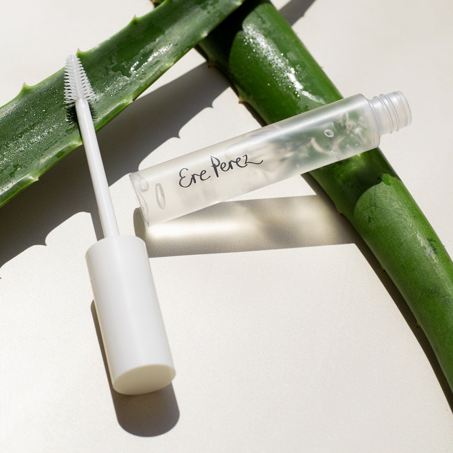 eco-friendly aloe gel lash & brow mascara by Ere Perez in its sustainable packaging on slices of its star ingredient: aloe
