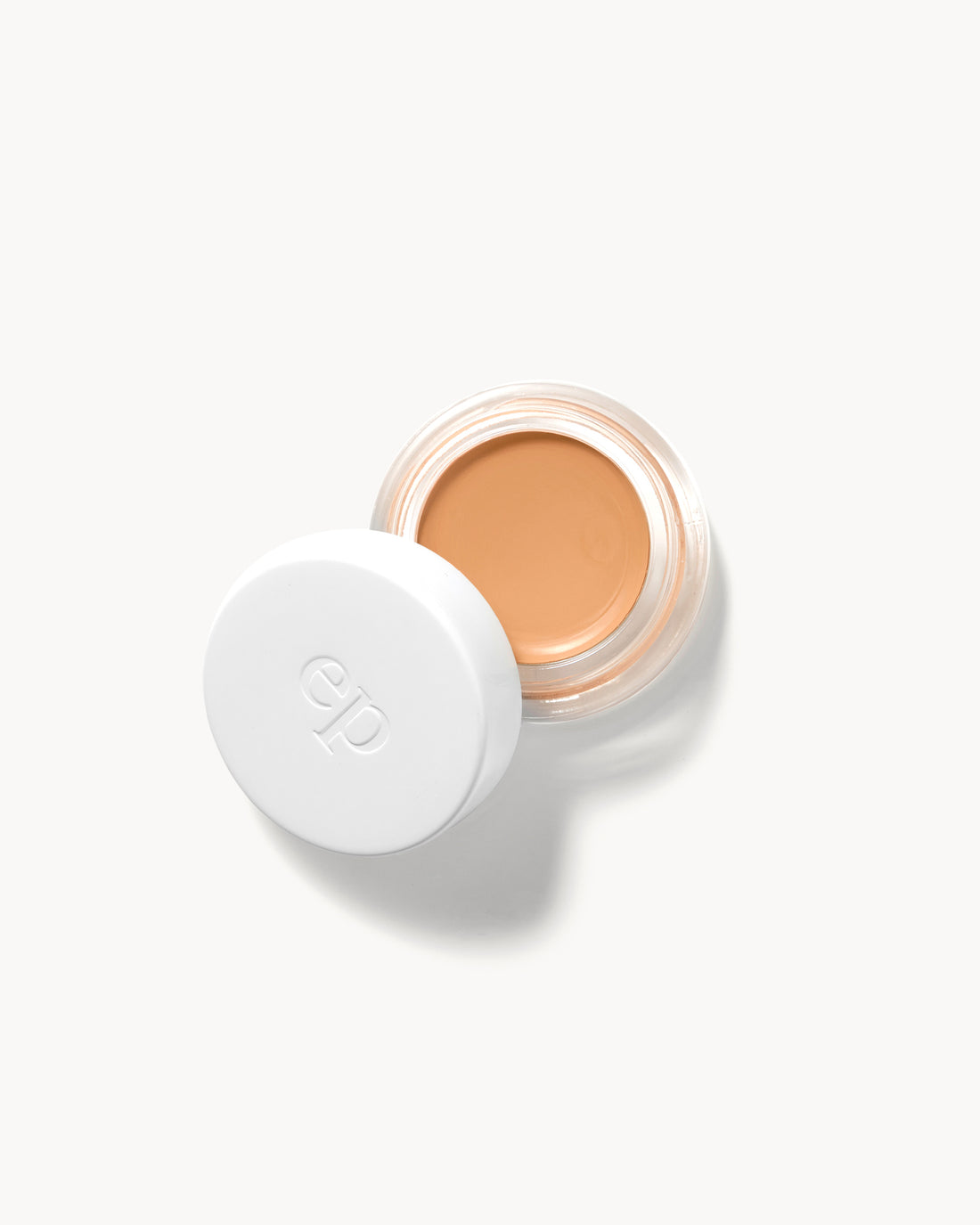 arnica all cover pot with a white lid on a light beige background