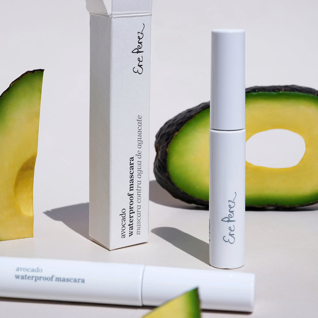 vegan & clean avocado waterproof mascara in its tube packaging surrounded by its star ingredient: avocado Ere Perez