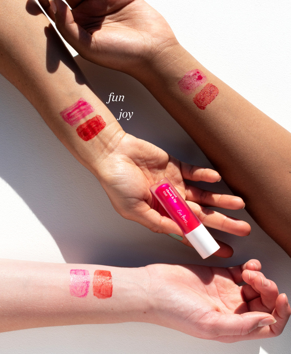 swatches of natural beetroot cheek & lip tint by Ere Perez on different skin tones