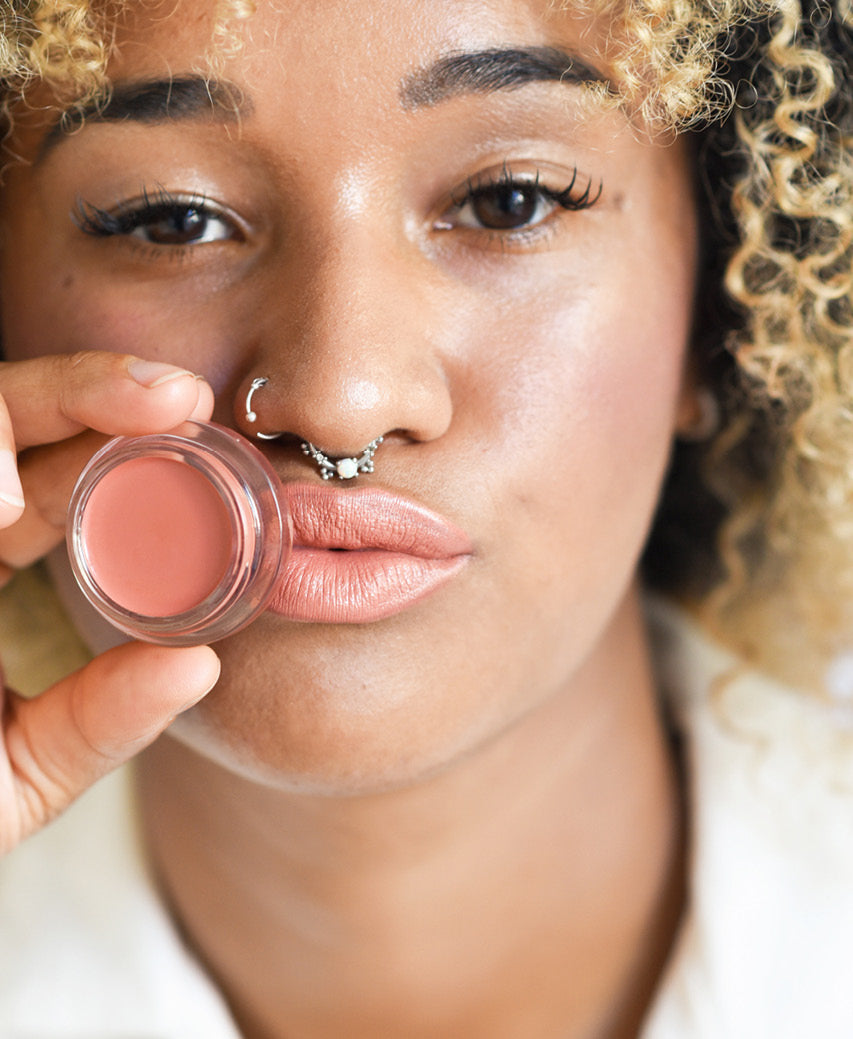 all-natural carrot colour by Ere Perez applied on the skin and in its pot for a gentle healthy colour and moisturised skin