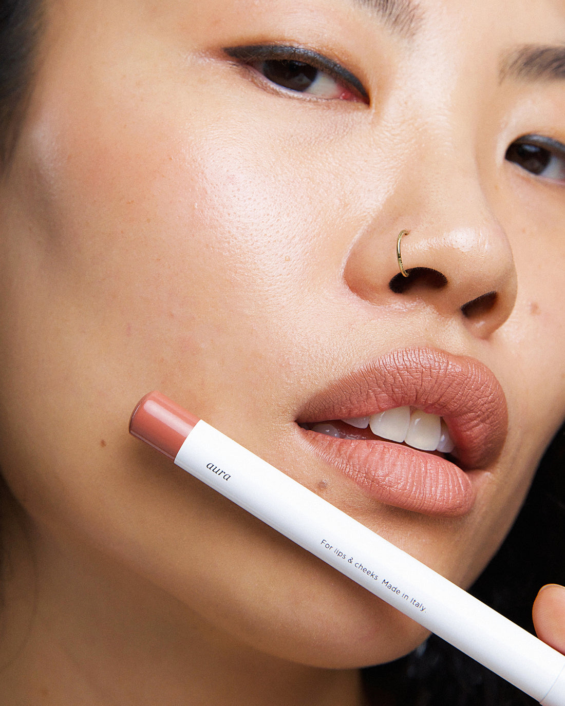gentle moisturising coco crayon by Ere Perez applied on skin and in its waste-free crayon for a natural long-lasting colour