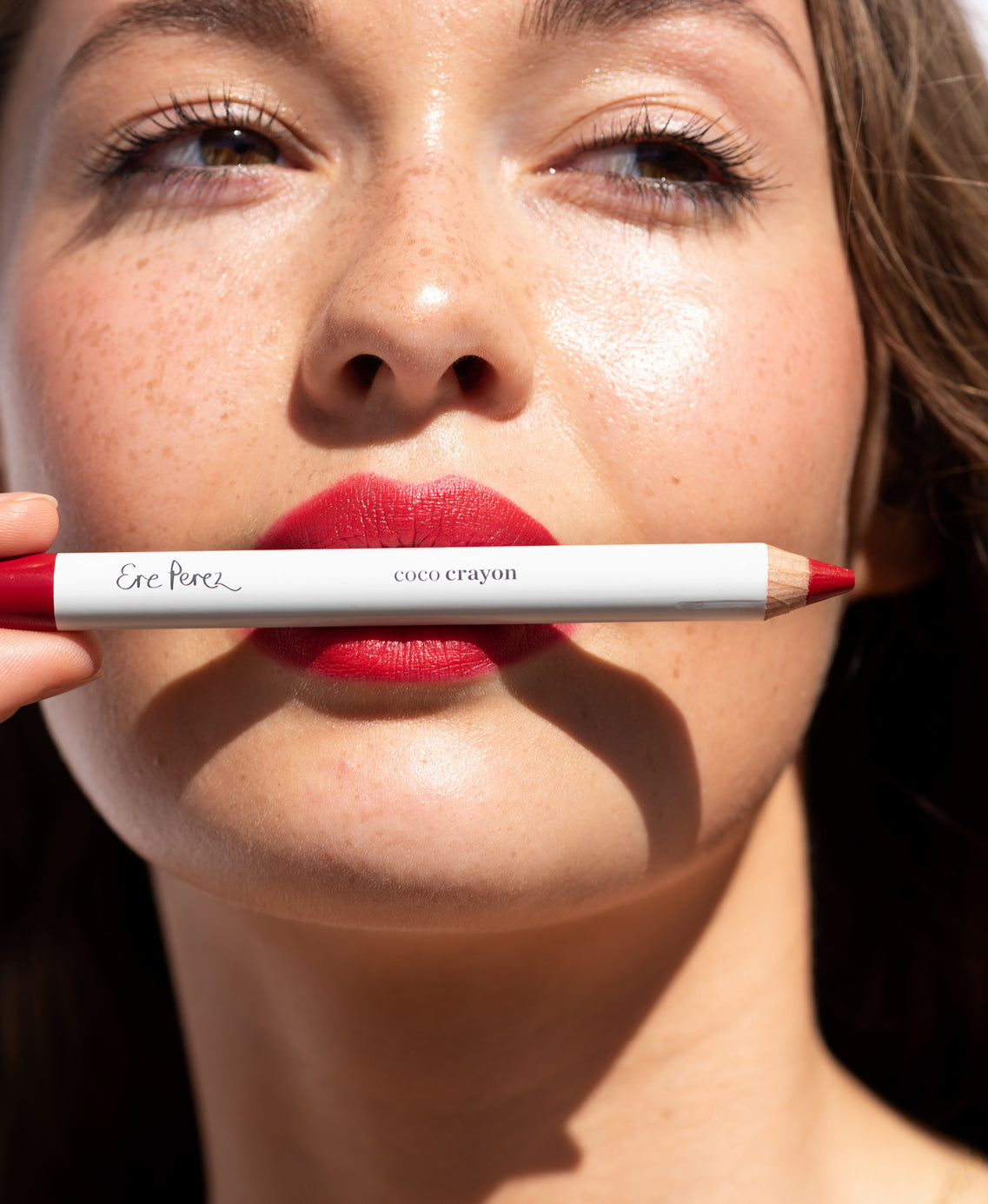 gentle hydrating coco crayon by Ere Perez applied on skin and in its waste-free crayon for a natural bold colour