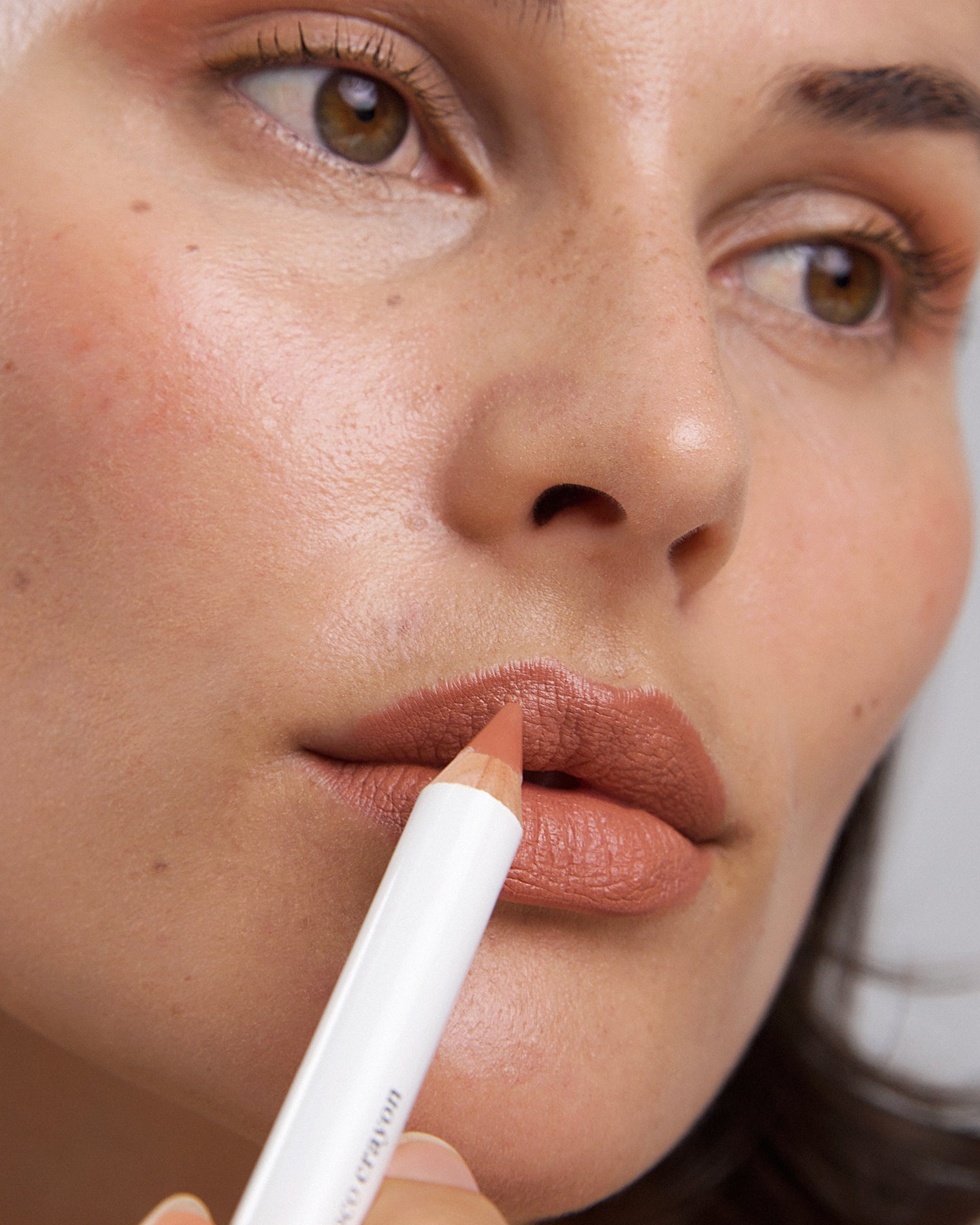 gentle moisturising coco crayon by Ere Perez applied on skin and in its waste-free crayon for a natural long-lasting colour