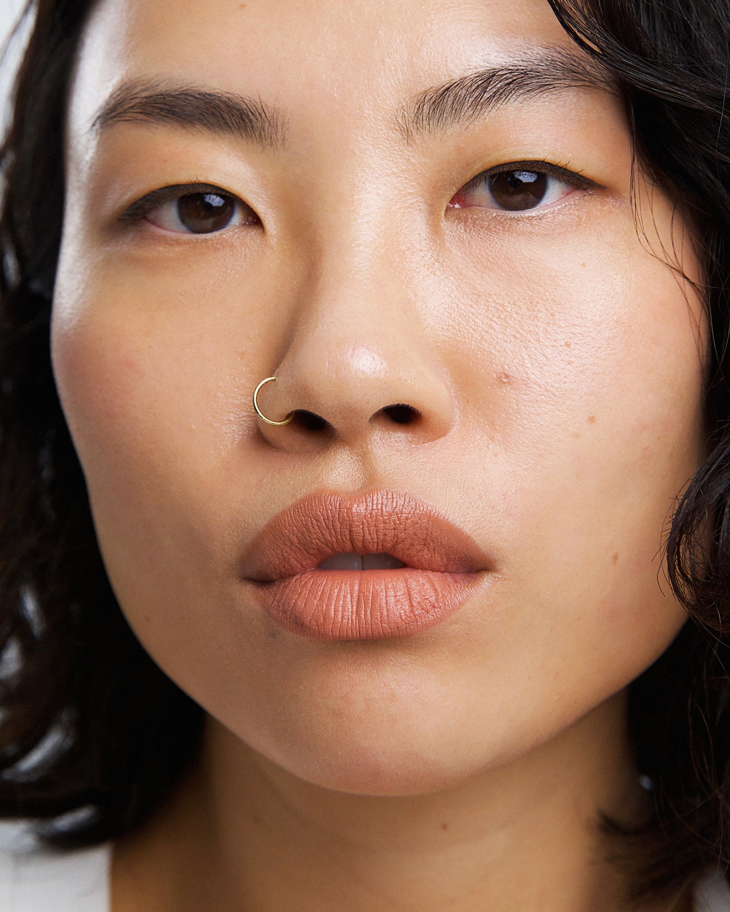 gentle moisturising coco crayon by Ere Perez applied on skin and in its waste-free crayon for a natural long-lasting colour