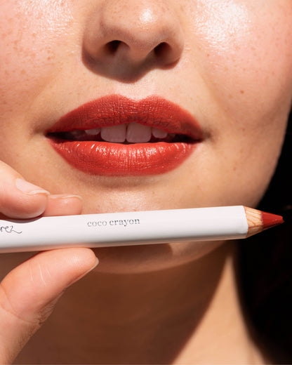 Ere Perez coco crayon in its pencil and applied on lips for a moisturised vibrant look