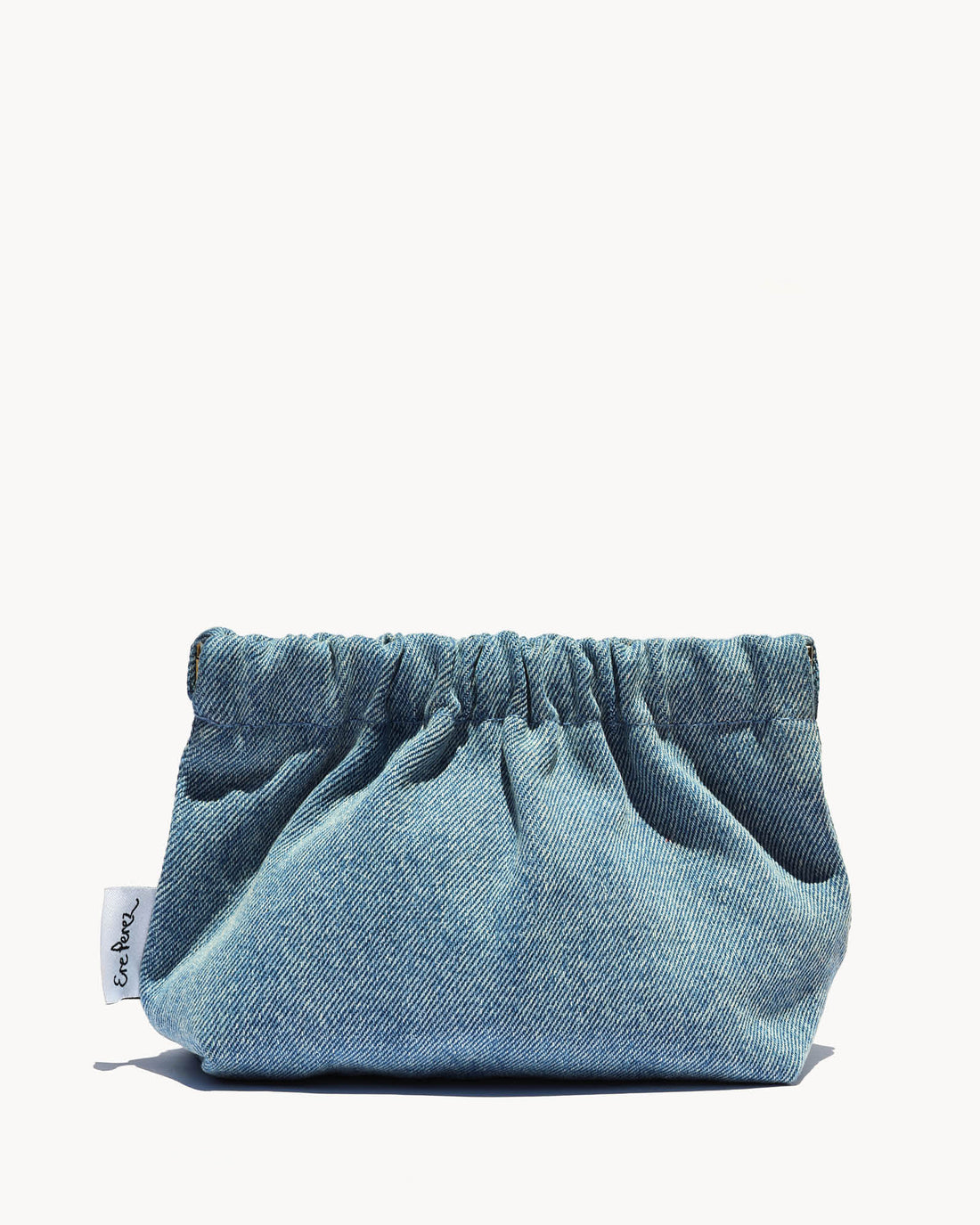Blue denim pouch with a brand tag on a white background