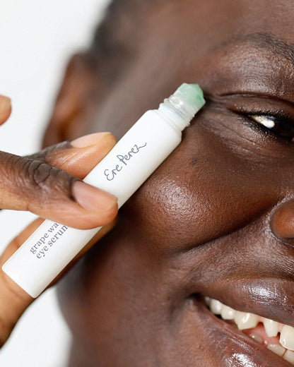 bio-grape water eye serum in its sustainable eye roller and applied on sensitive skin