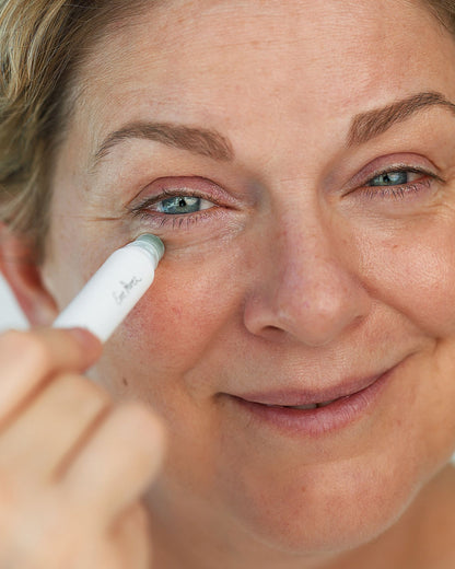 eco-friendly grape water eye serum in its sustainable eye roller and applied on the skin for moisturised skin