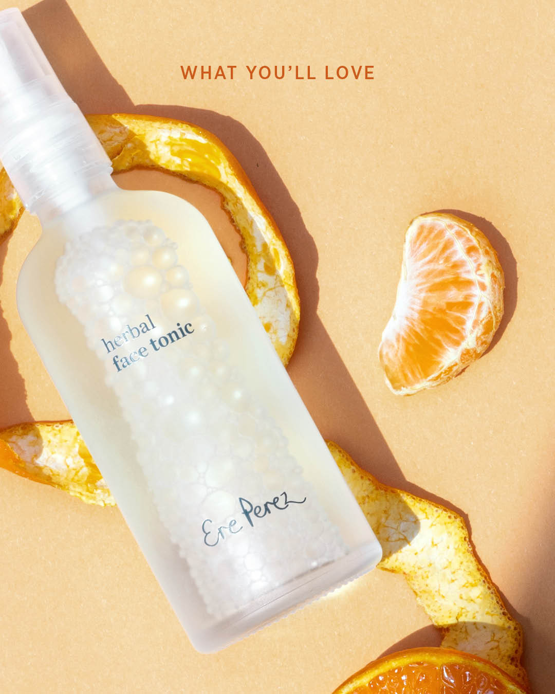 natural herbal face tonic next to its essential ingredient: mandarin