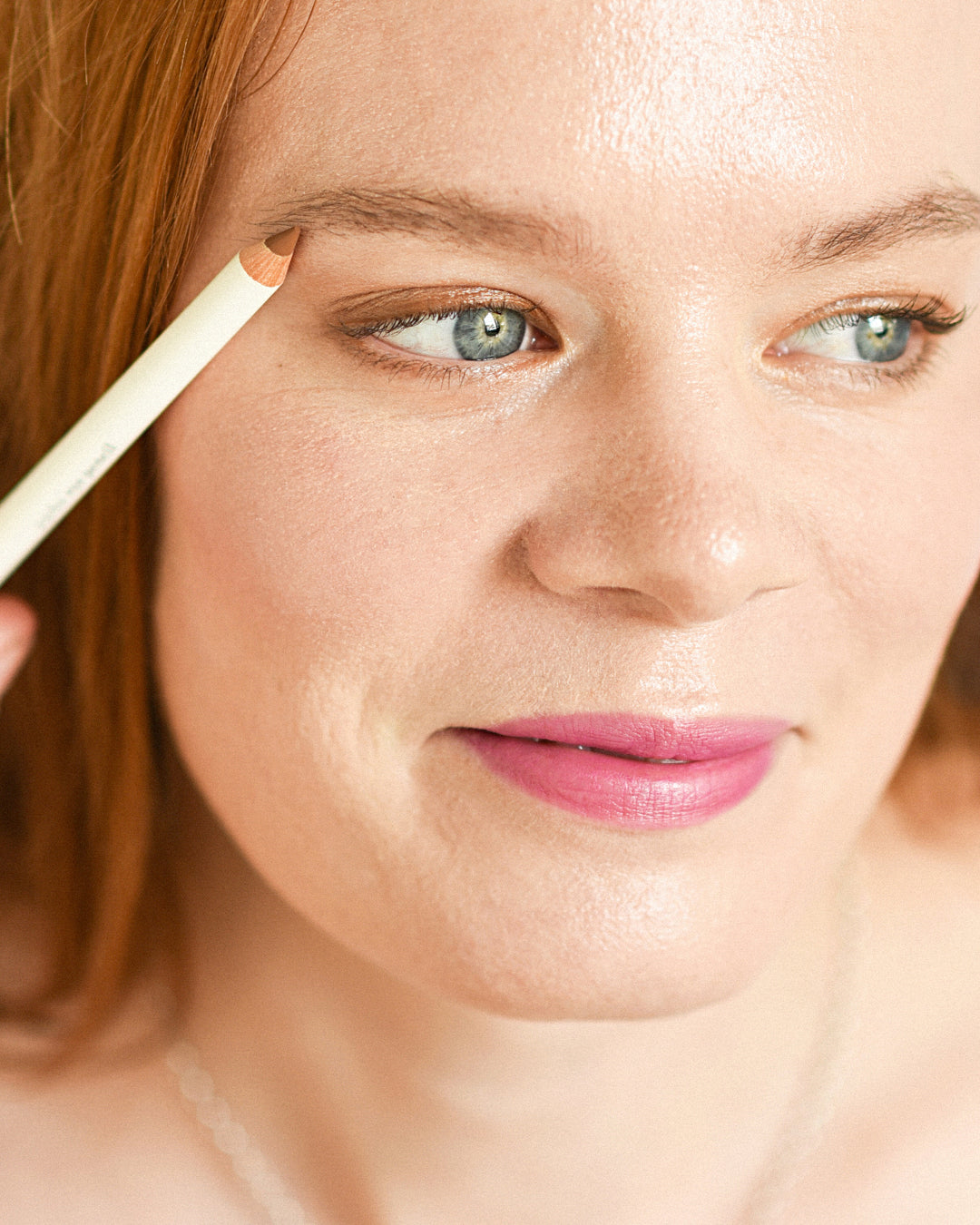 coloured eyelids, brows and lashes applied with natural jojoba eye pencil