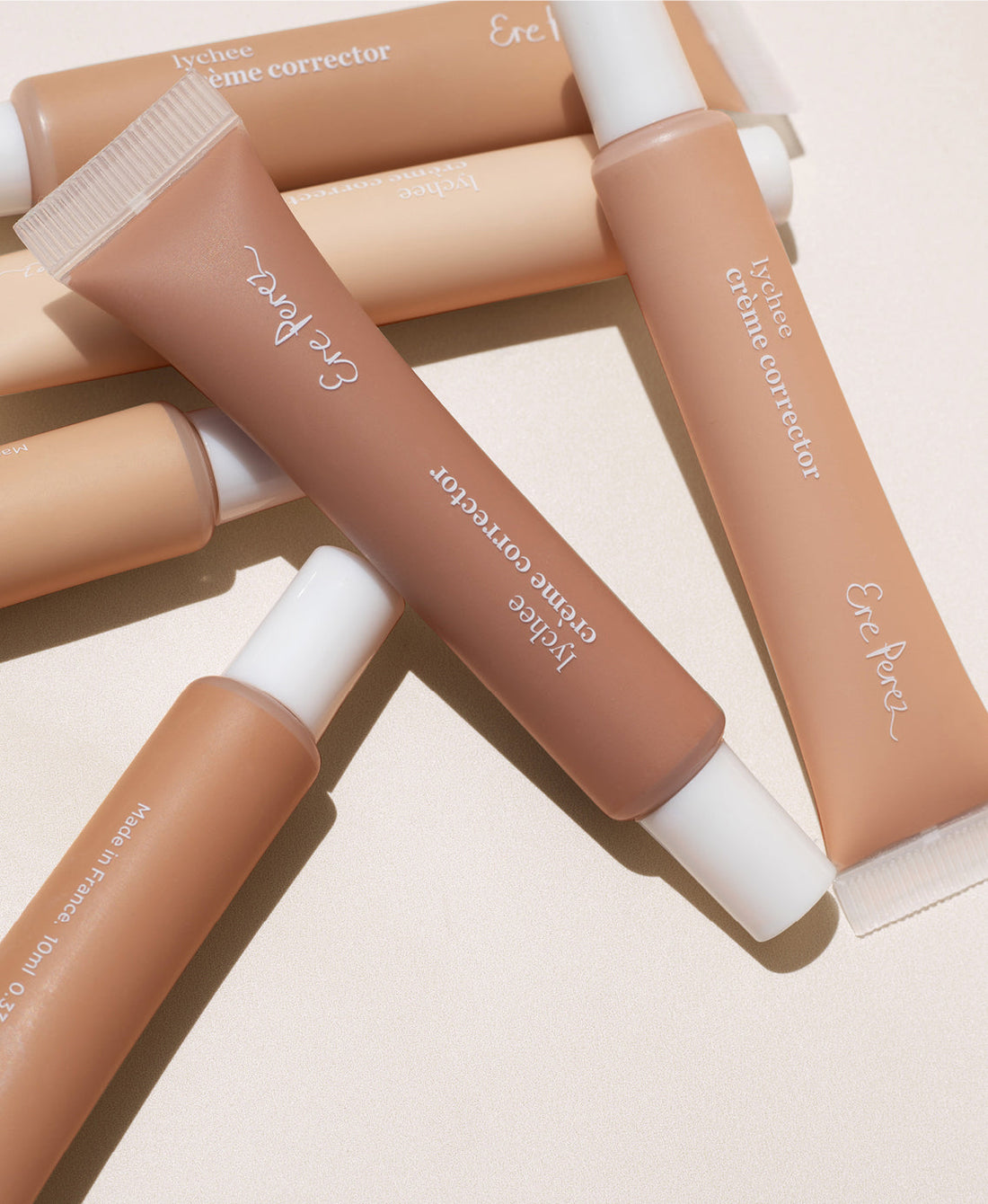 Bottles of various shades of natural & brightening lychee creme corrector by Ere Perez