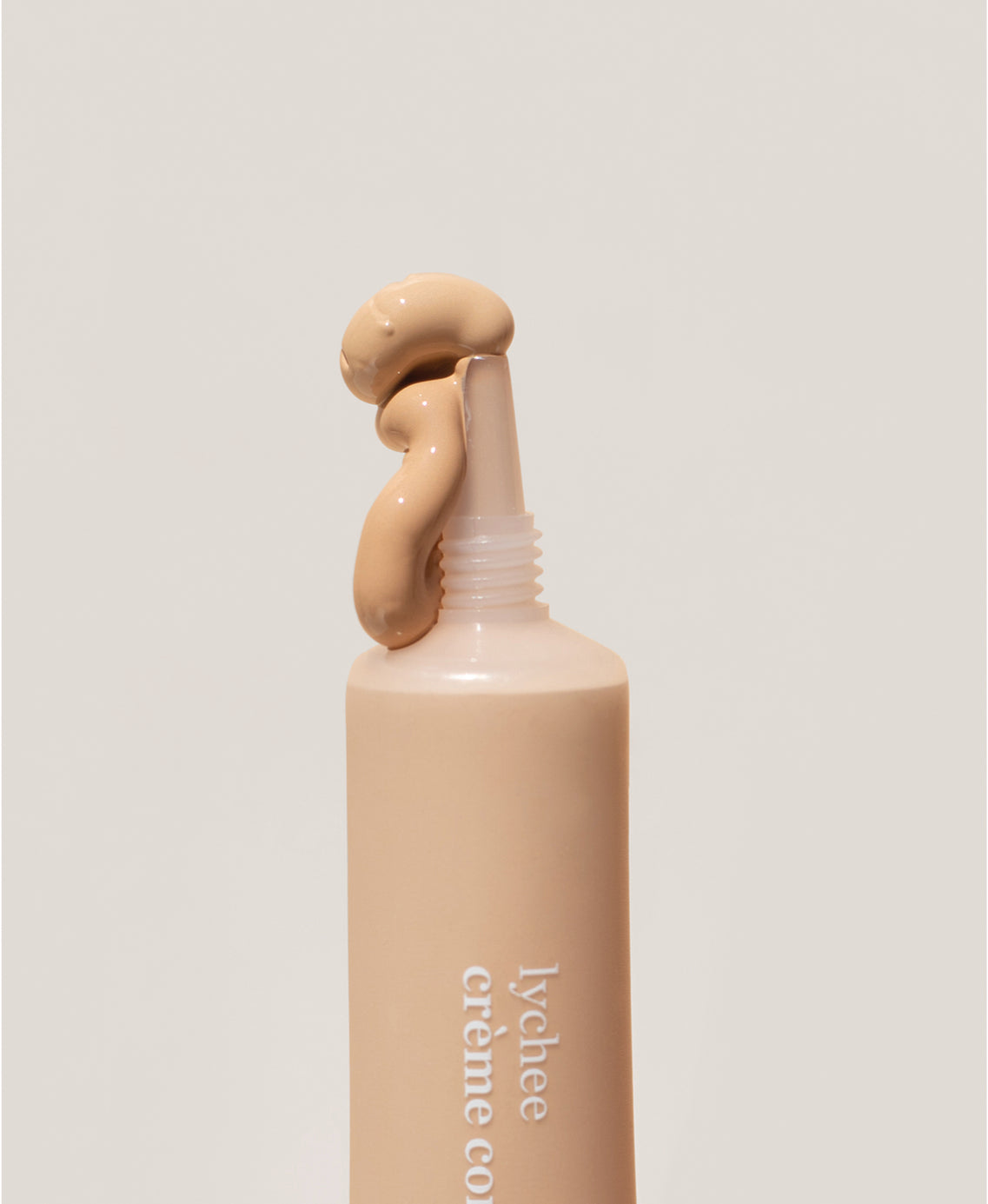 Bottle of all-natural lychee creme corrector and it&