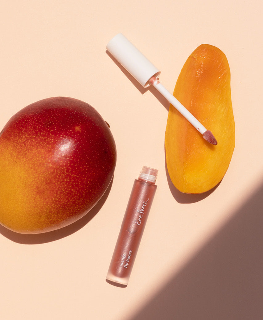 organic mango lip honey Ere Perez next to its star ingredient: mango