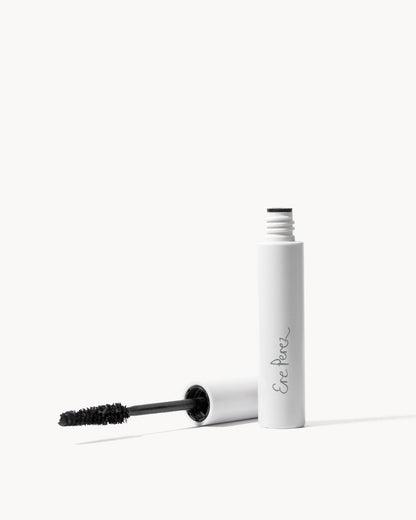Eyelash mascara with white casing and black wand on a white background