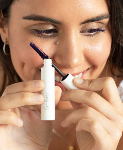 natural almond mascara by Ere Perez in its tube and applied on the eyes for a statement look