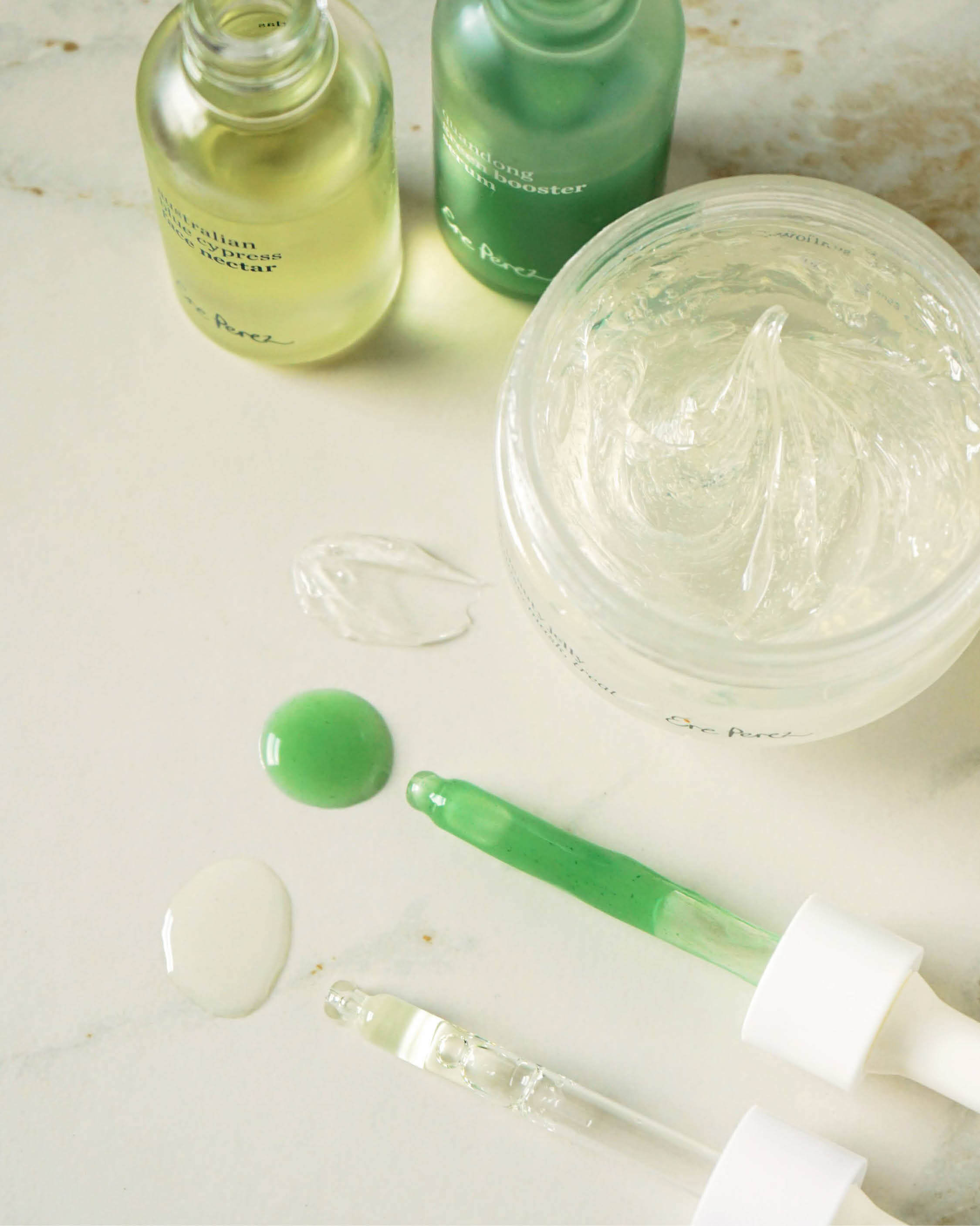 swatches of quandong green booster serum, Australian blue cypress face nectar and fig all beauty jelly by Ere Perez