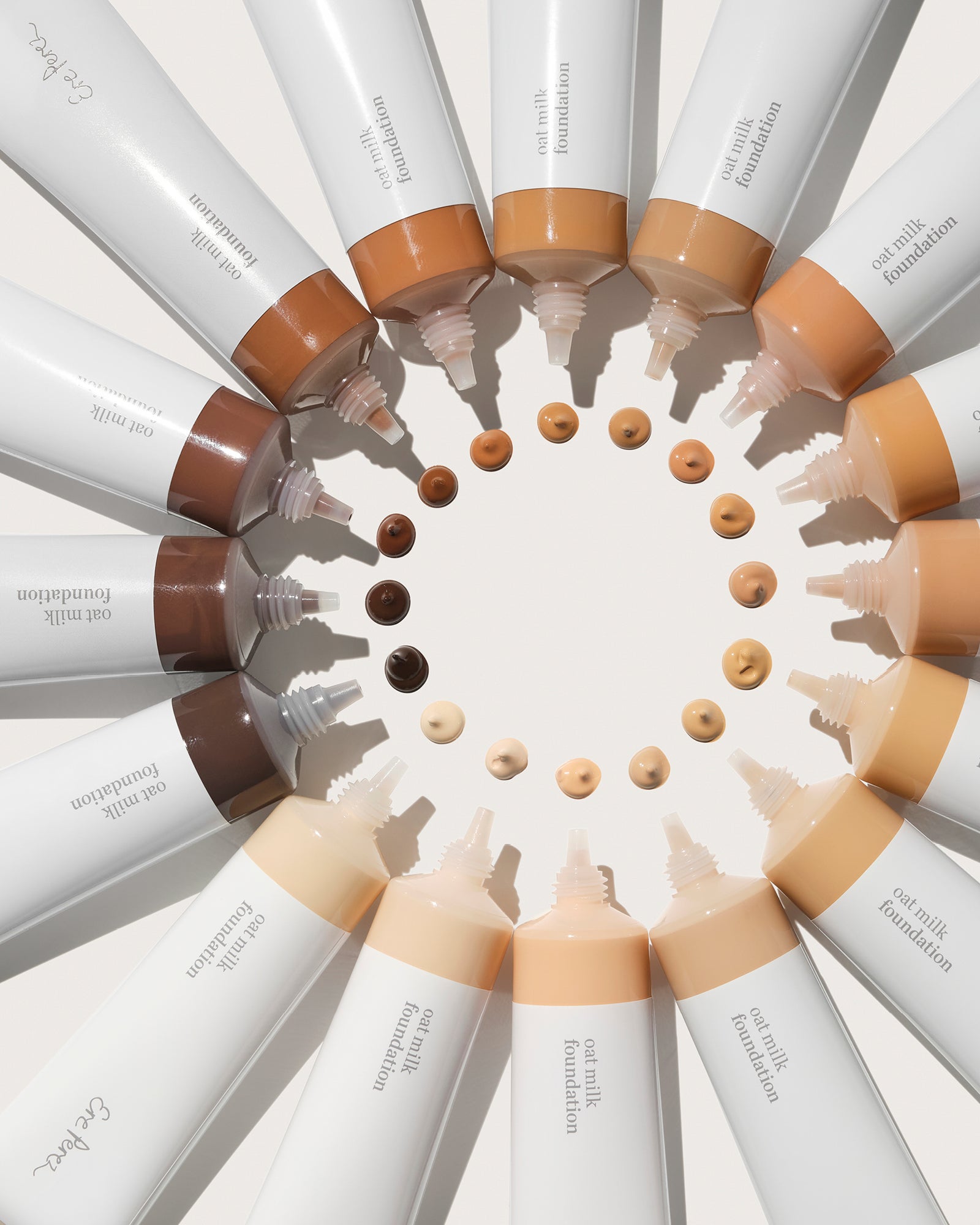 Foundation bottles arranged in a circular pattern with different shades of foundation.