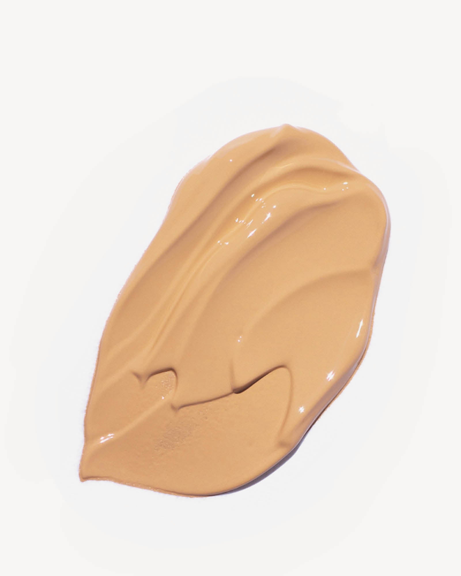 Beige makeup swatch in shade chai on a white background,