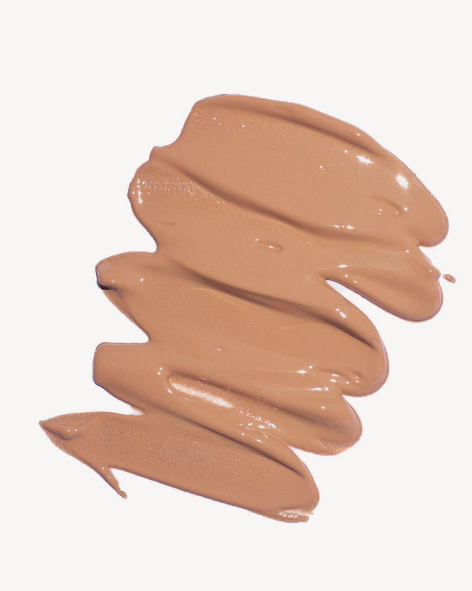 Swatch of brown makeup cream in shade maple on a white background,