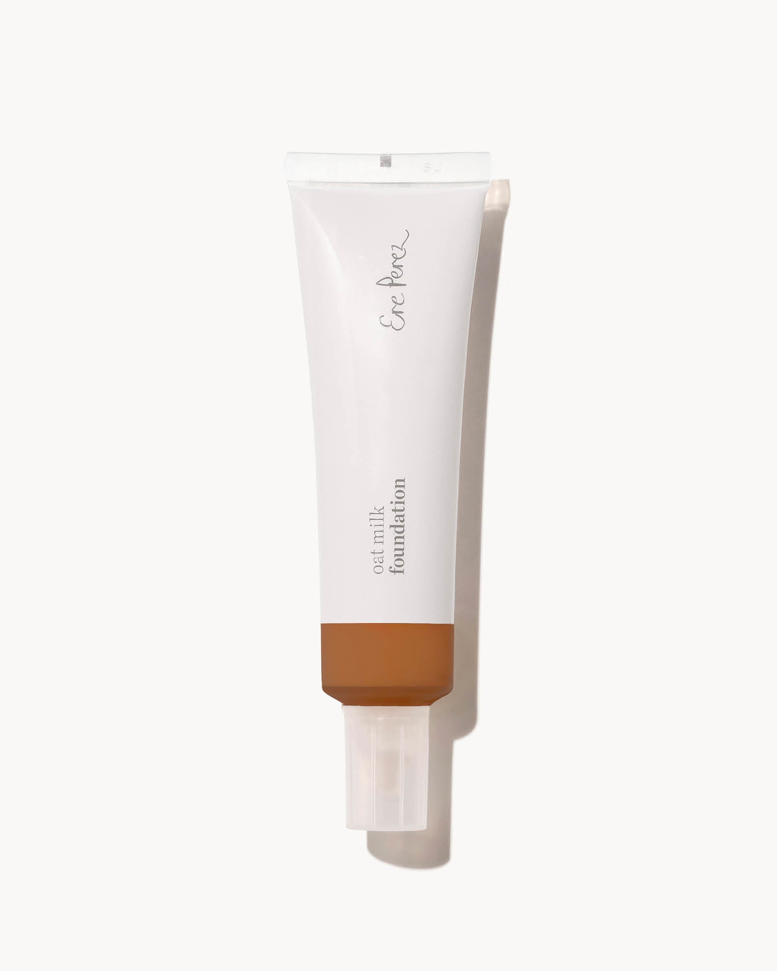 Tube of foundation with a brown shade on a white background.