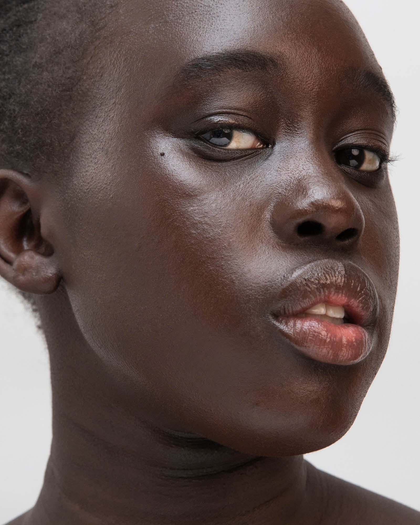 Close-up of a person with a neutral expression on a plain background