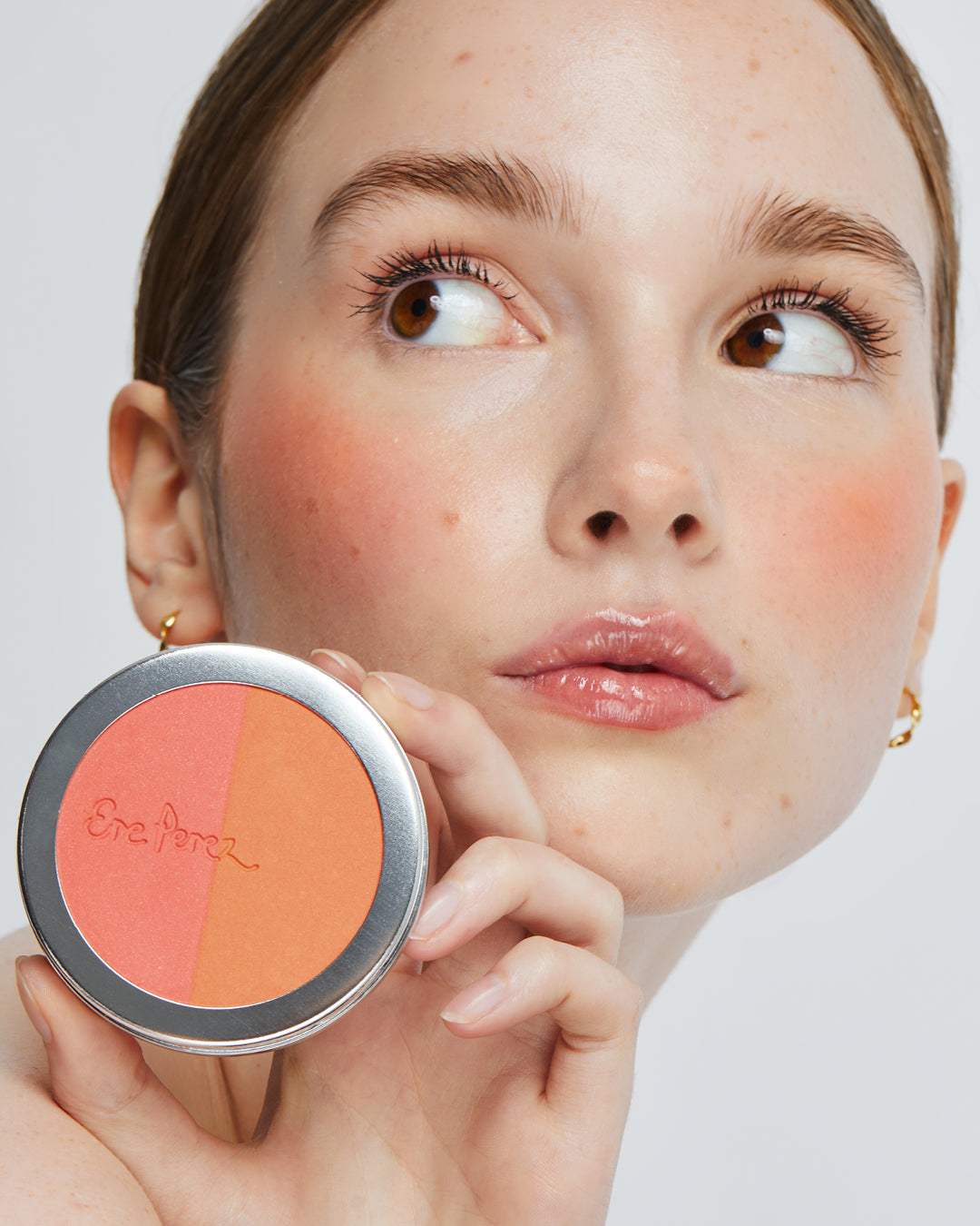 natural & gentle rice powder blush in its wheel and applied on skin for rosy cheeks