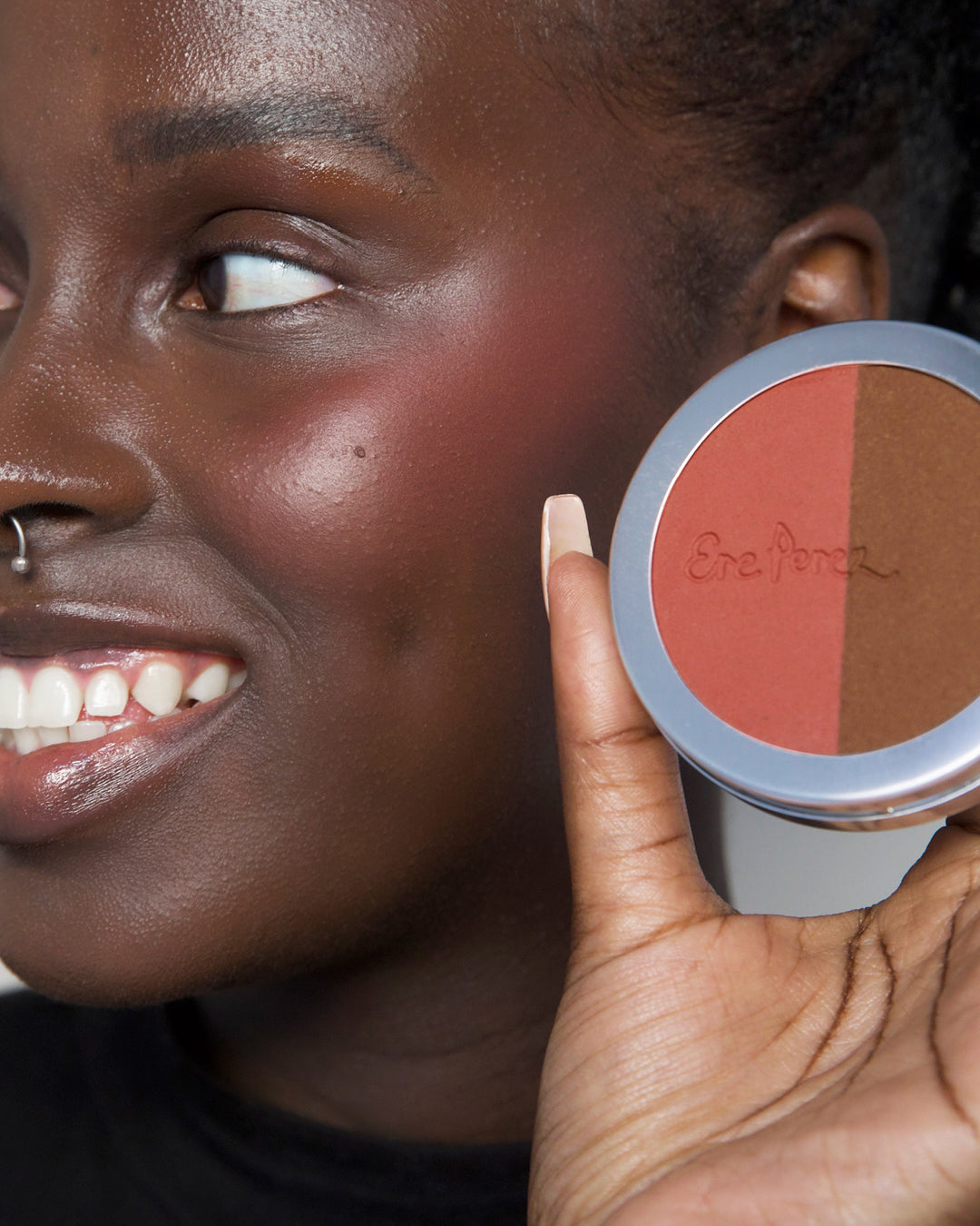 natural rice powder blush & bronzer refill by Ere Perez in wheel and applied to skin to accentuate features