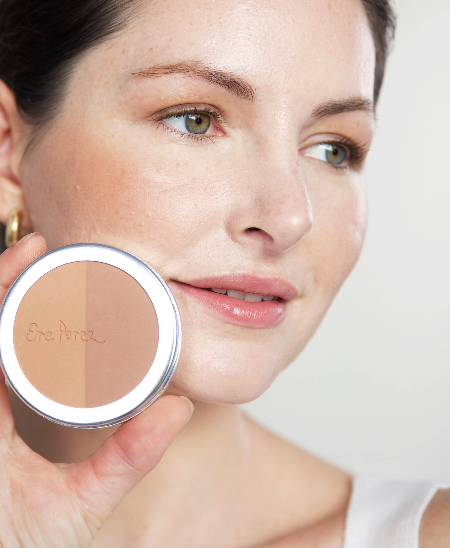 all-natural gentle rice powder bronzer & blush in its wheel and applied on skin for toned features