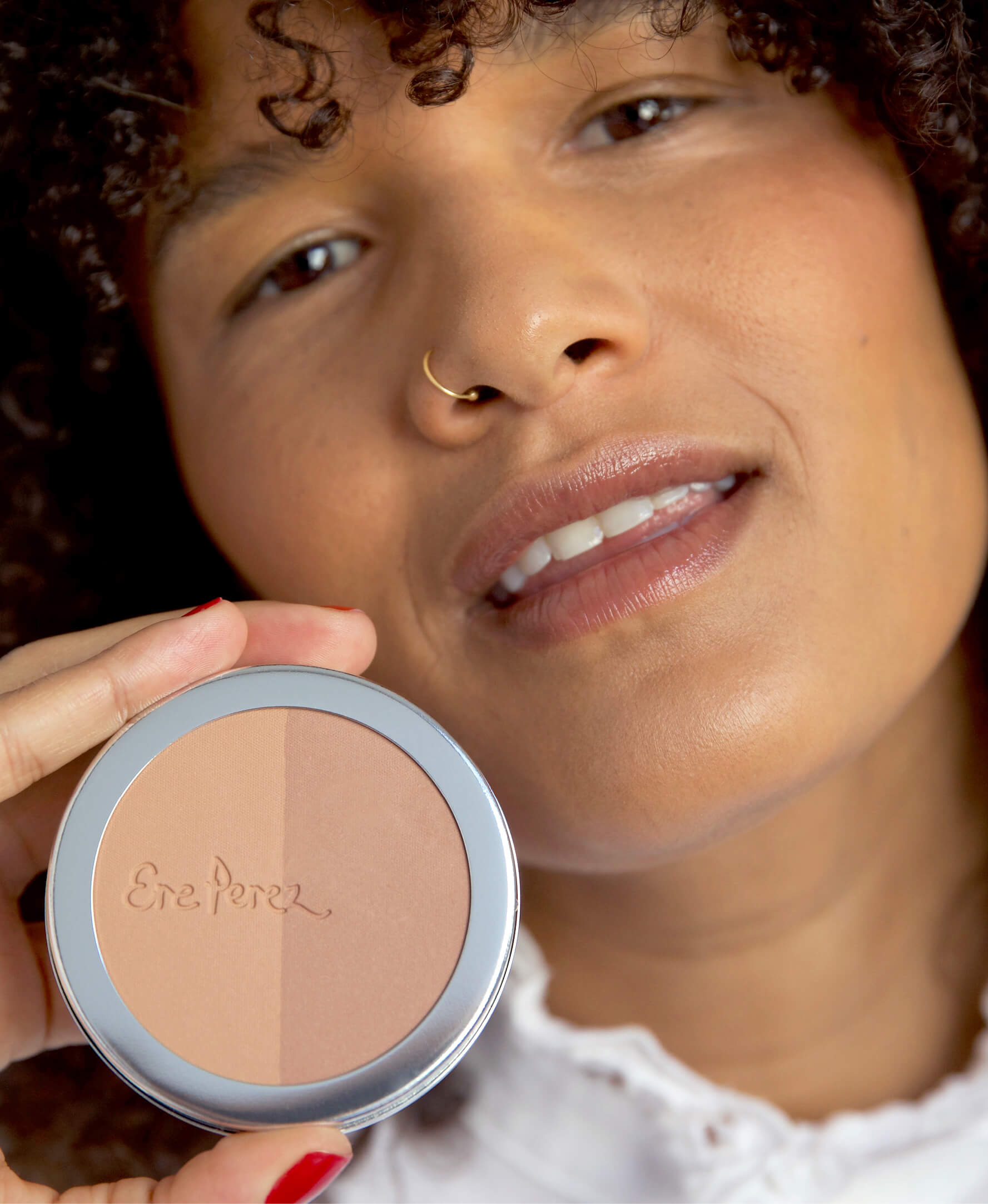 all-natural & gentle rice powder bronzer & blush in its wheel and applied on skin for radiant skin