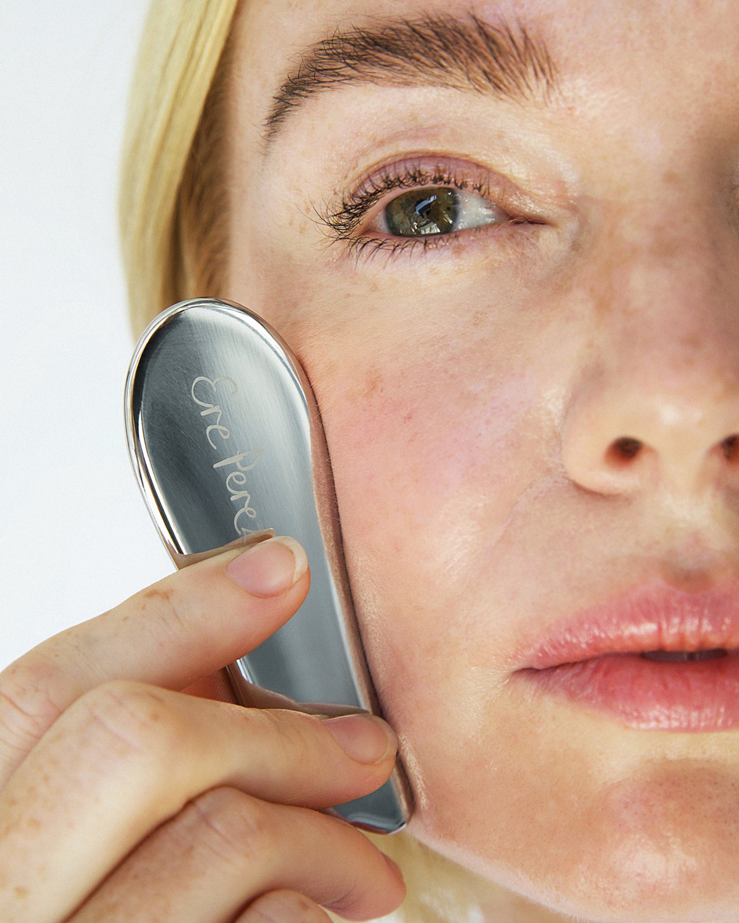 natural & durable stainless-steel gua sha used to apply product on the skin for a sculpted look