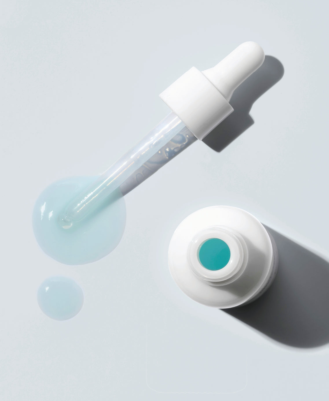 swatch and bottle of organic white tea phyto-retinol elixir by Ere Perez |