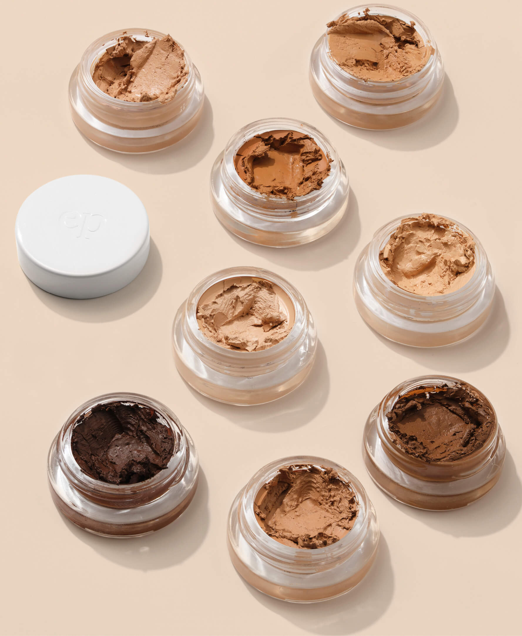Pots of various shades of natural and gentle arnica all-cover concealer