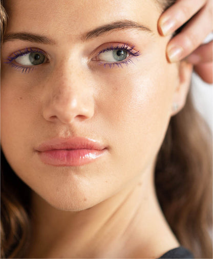 Purple natural almond mascara by Ere Perez applied on the lashes for a pop of colour