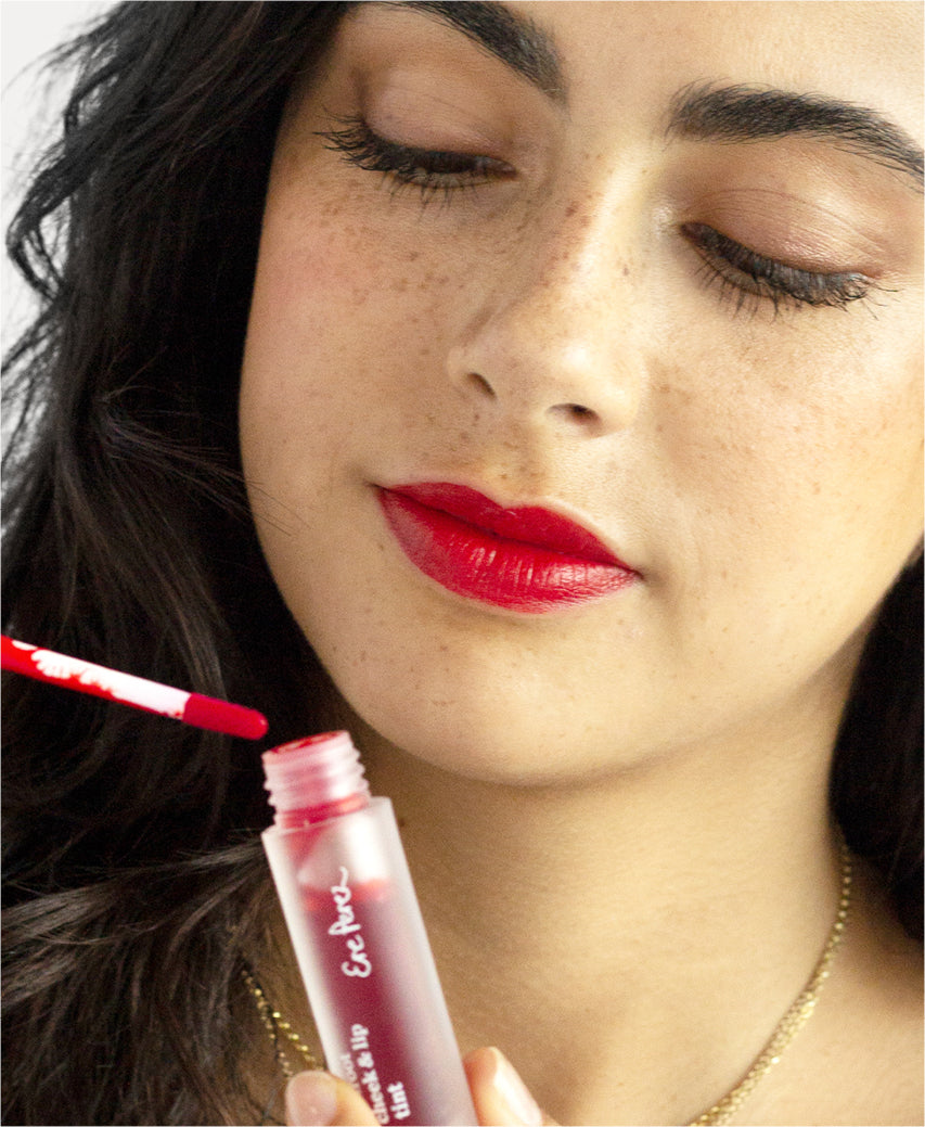 natural beetroot cheek & lip tint by Ere Perez applied on the skin and in its multi-use bottle for a glowy face