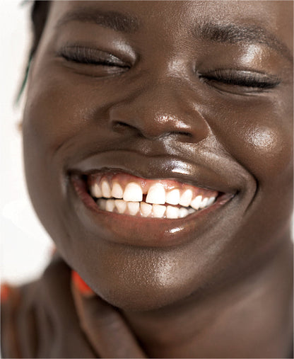 clear cruelty-free mango lip honey by Ere Perez applied on the lips for a hydrating gloss