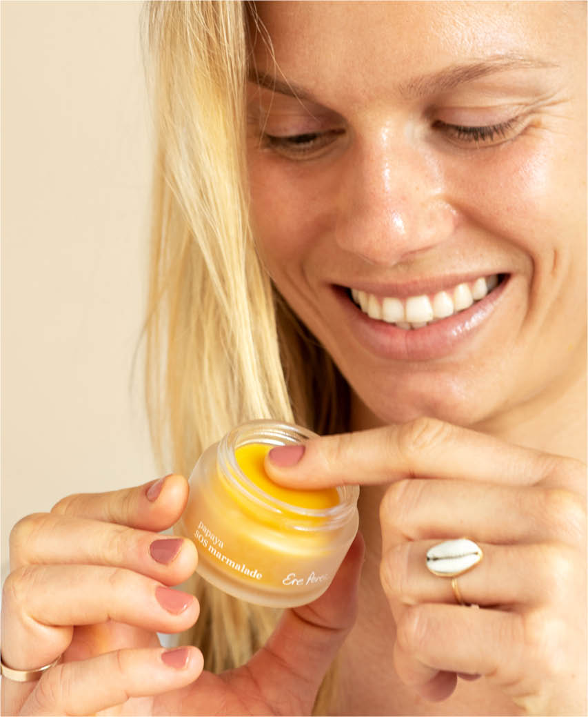 Natural papaya SOS marmalade Ere Perez in its sustainable pot and applied on skin for a refreshing rejuvenating effect