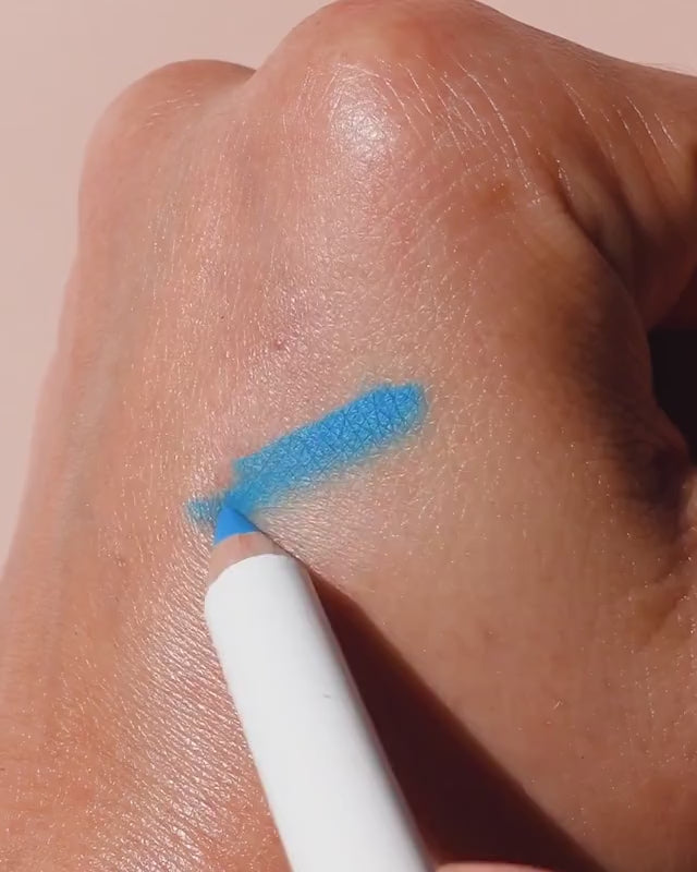 swatch of blue jojoba eye pencil by Ere Perez applied and smudged on eye for a refreshed smokey look