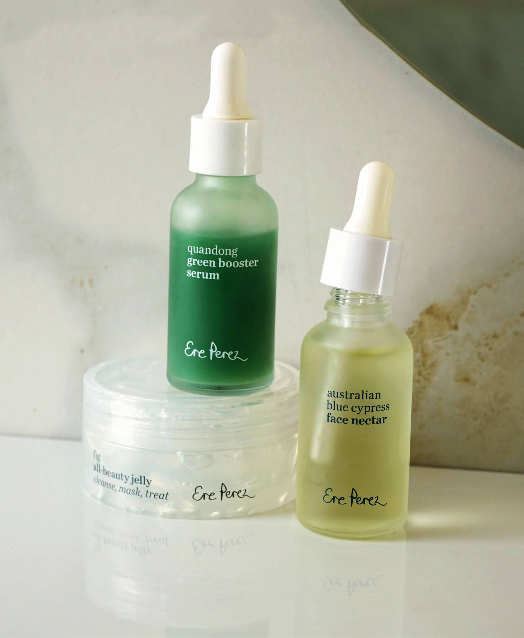 Natural discovery set combo by Ere Perez for a simple skincare routine, with bottle of quandong green booster serum, bottle of Australian blue cypress face nectar and pot of fig all beauty jelly