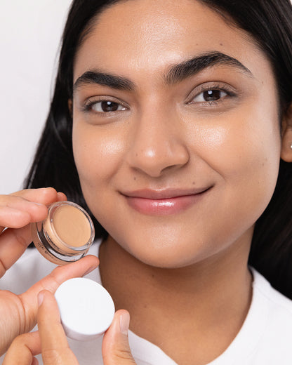 Close-up of a person who has applied Arnica All Cover Pot to their face. Arnica All Cover Pot in the shade brew 