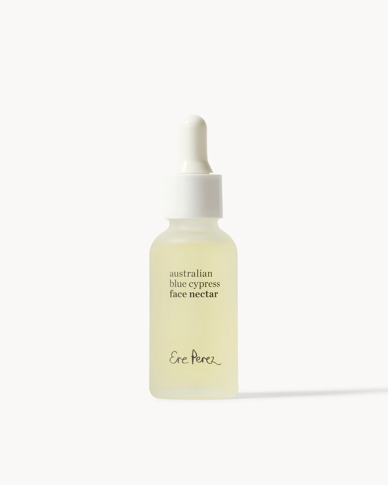 Skincare dropper bottle labeled 'Australian Blue Cypress Face Nectar' by Ere Perez on a white background