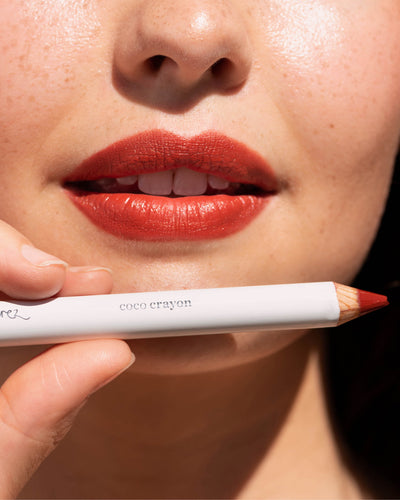 Ere Perez coco crayon in its pencil and applied on lips for a moisturised vibrant look