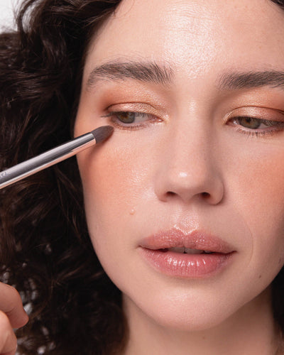Tapered eye duo brush applying eyeshadow