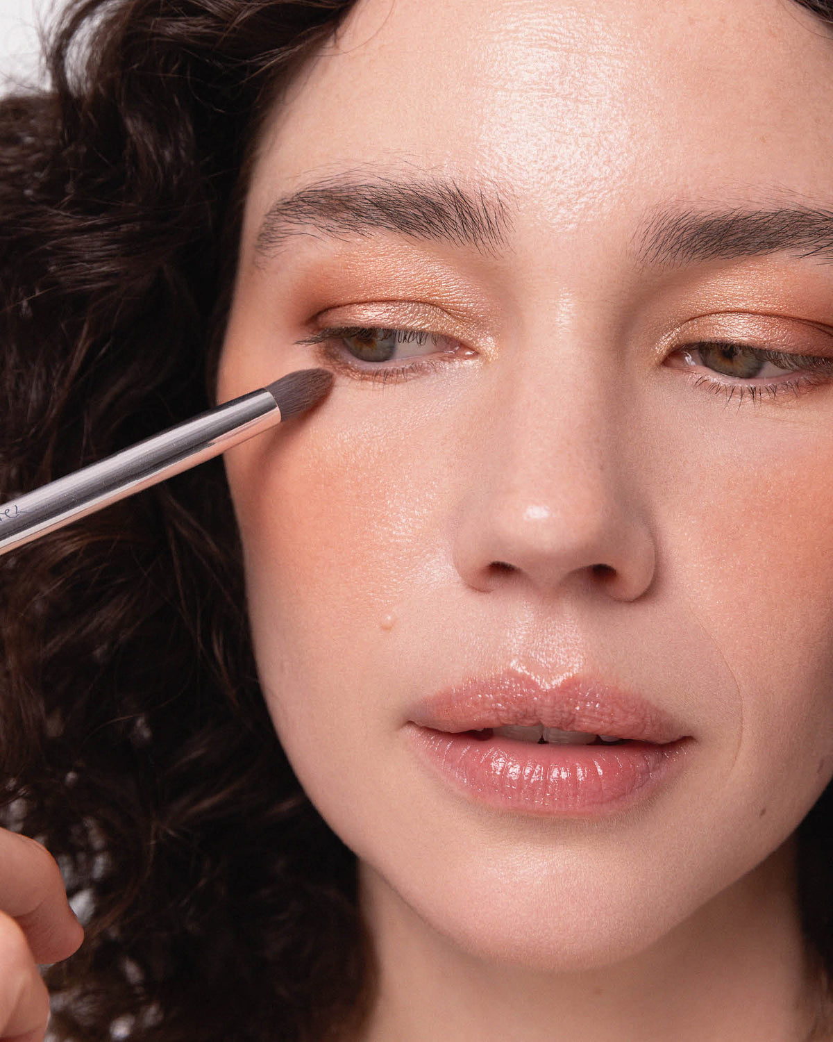 Tapered eye duo brush applying eyeshadow