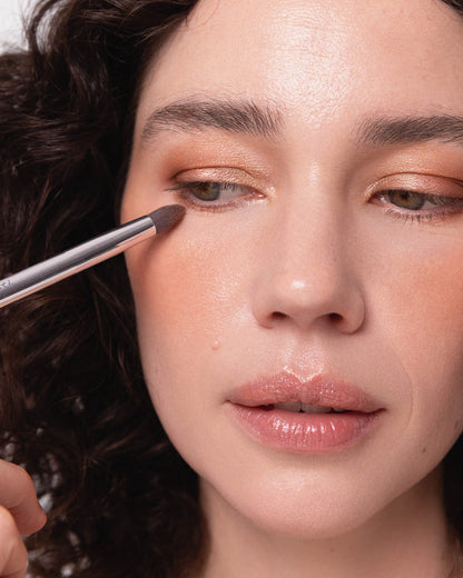 Tapered eye duo brush applying eyeshadow