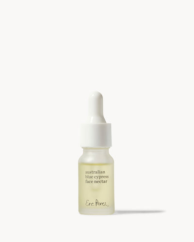 A small glass dropper bottle of Ene Porek Australian Blue Cypress Face Nectar with pale yellow liquid inside, set against a clean off-white background 