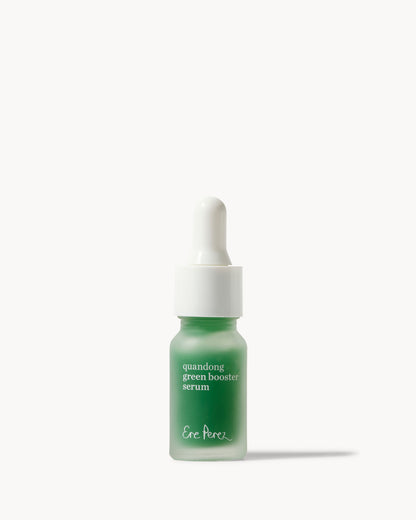 A small dropper bottle of Ere perez Quandong Green Booster Serum with a frosted green glass bottle and a white dropper cap, centered on a clean off-white background 