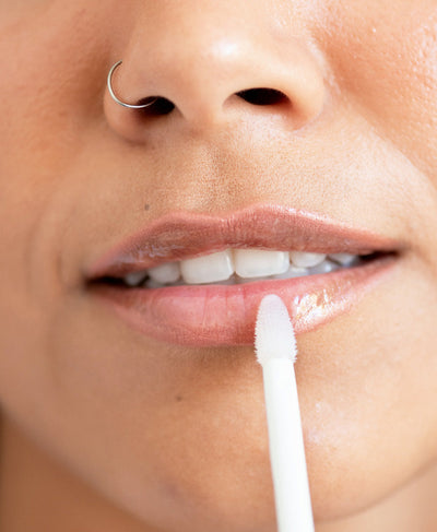 clear cruelty free mango lip honey by Ere Perez applied on the lips for a moisturising gloss 