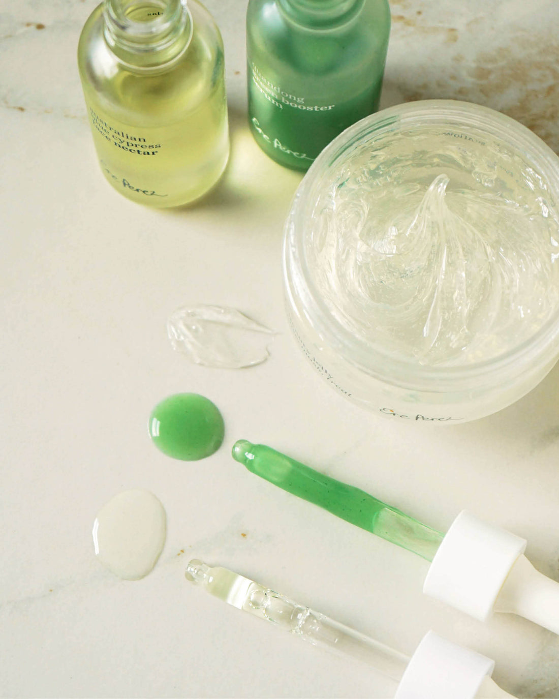 swatches of quandong green booster serum, Australian blue cypress face nectar and fig all beauty jelly by Ere Perez